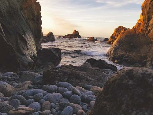 big sur landscape photography of rock formations and body of water cliff
